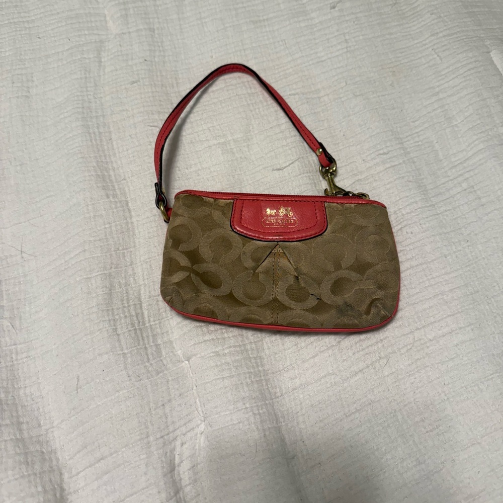 Coach wristlet in signature print with coral leather trim